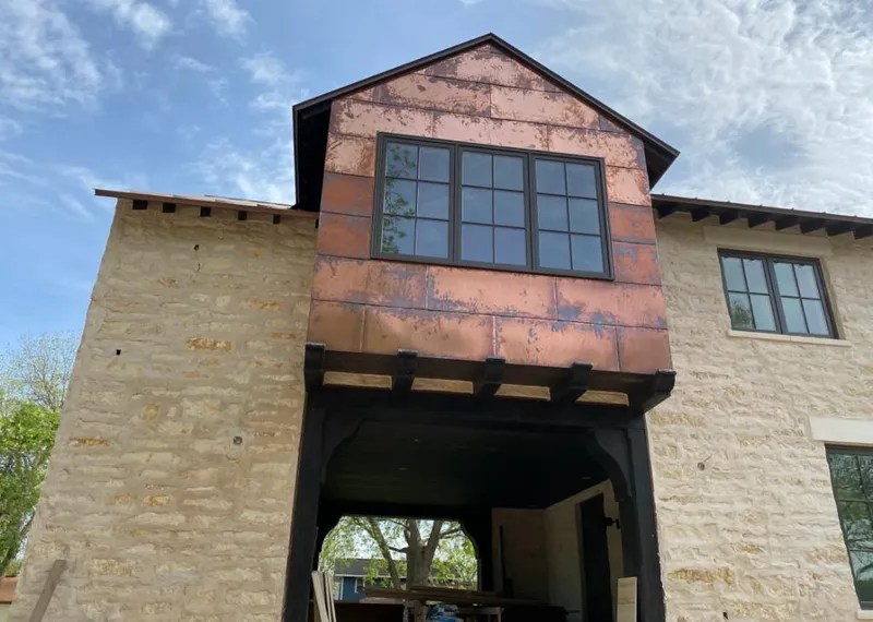 Copper metal panel facade on a stone building for Skylight Installation in Kihei